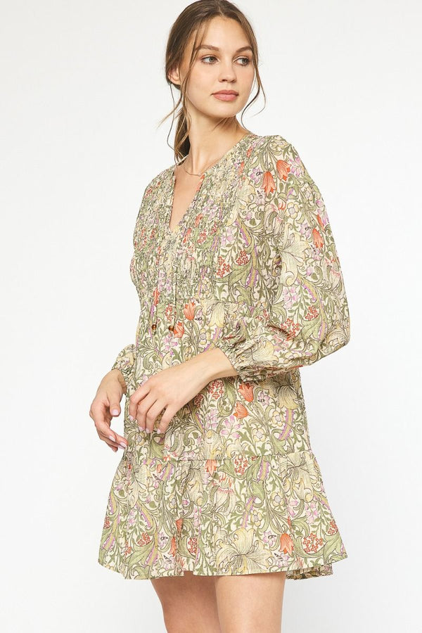 Floral paisley print tiered long sleeve mini dress featuring self-tie detail at neckline